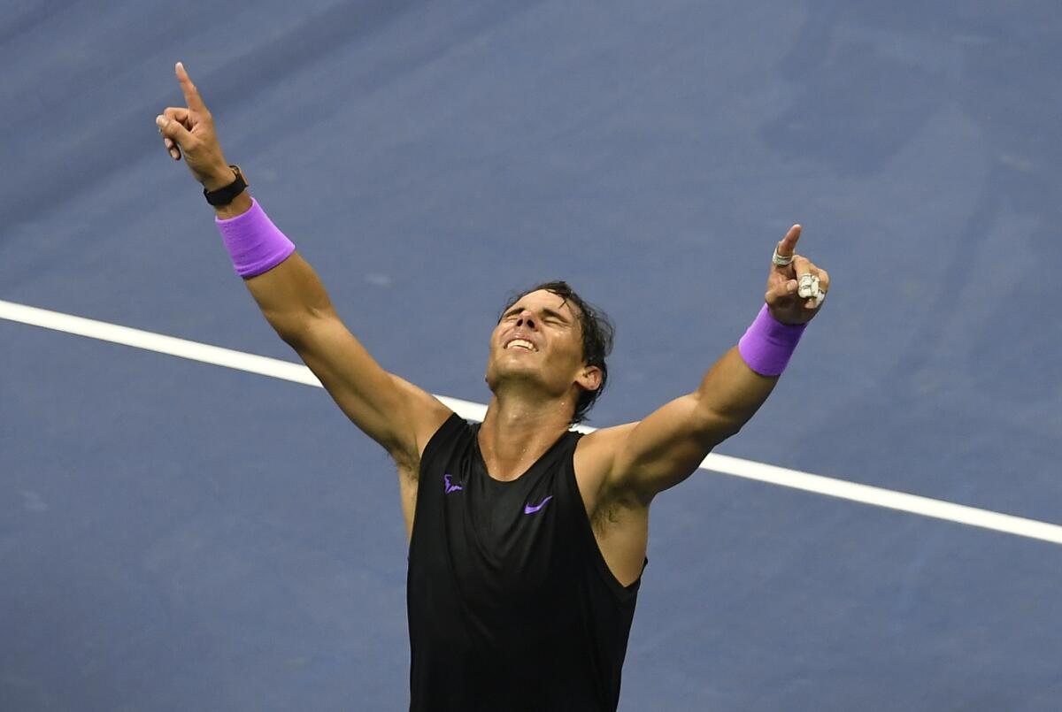 Rafael Nadal raises his arms after defeating Daniil Medvedev to win the 2019 U.S. Open title.