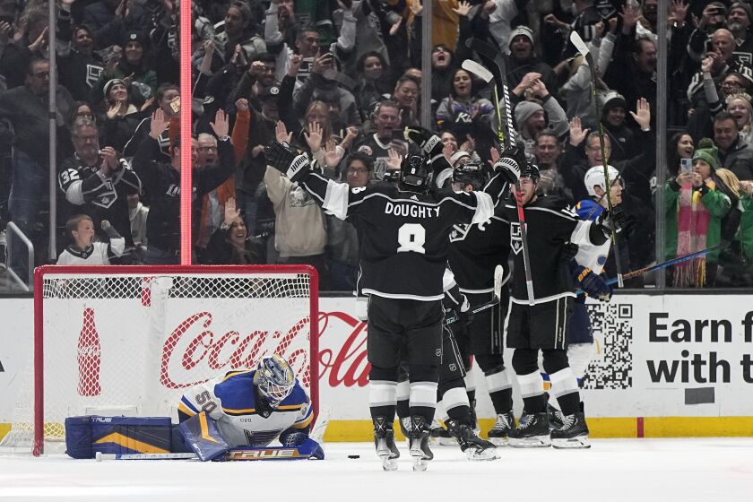 Los Angeles Kings defenseman Drew Doughty (8) celebrates a goal by right wing Gabriel Vilardi with teammates as St. Louis Blues goaltender Jordan Binnington (50) lays on the ice during the third period of an NHL hockey game Saturday, March 4, 2023, in Los Angeles. (AP Photo/Mark J. Terrill)