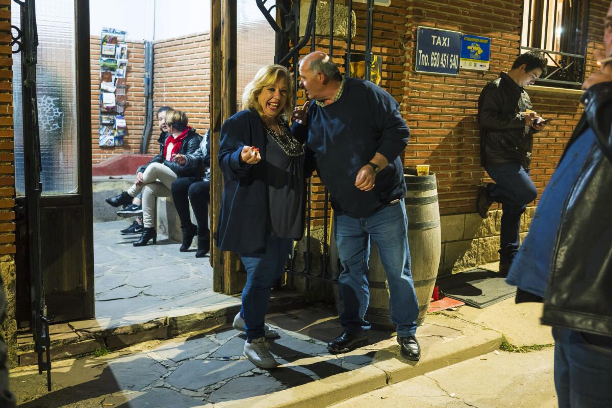 Ana Maria Almunia chats with a gentleman outside the dance room in Calzadilla de la Cueza, Spain.