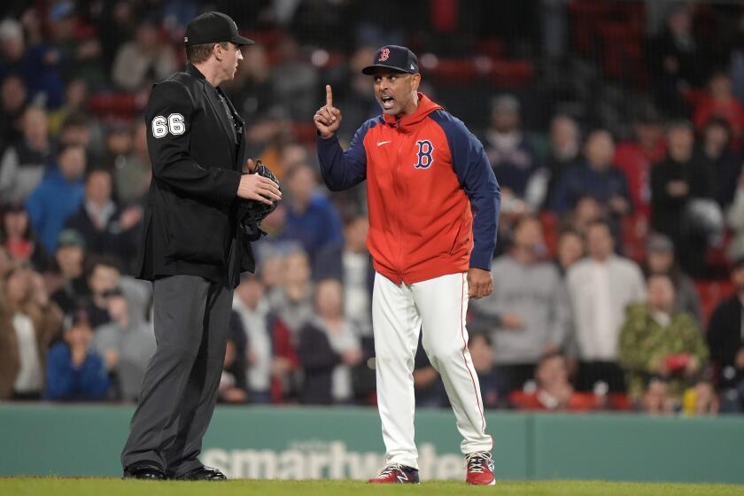 Boston Red Sox manager Alex Cora, right, argues with umpire Alex Tosi, left, during the ninth inning of the team's baseball game against the Tampa Bay Rays, Thursday, May 16, 2024, in Boston. The Rays had lost track of mound visits when catcher Ben Rortvedt went out to speak with Jason Adam earlier in the inning. (AP Photo/Steven Senne)