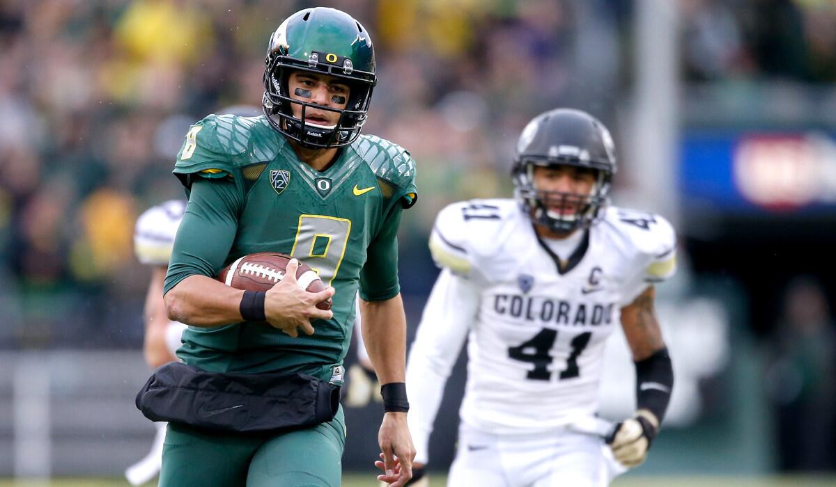 Oregon quarterback Marcus Mariota breaks into the clear against Colorado on a 46-yard touchdown run in the first quarter Saturday.
