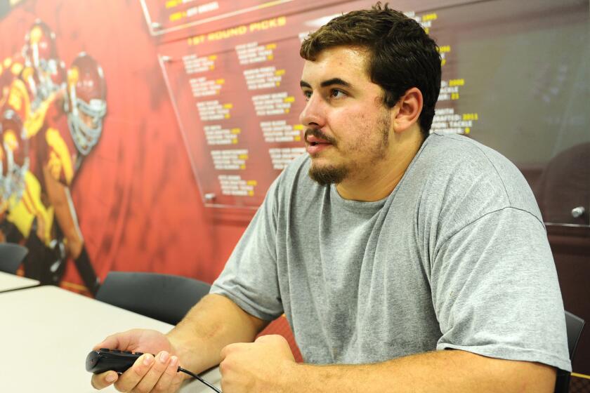 USC center Max Tuerk watches game film in July 2014 as he prepares for the season.