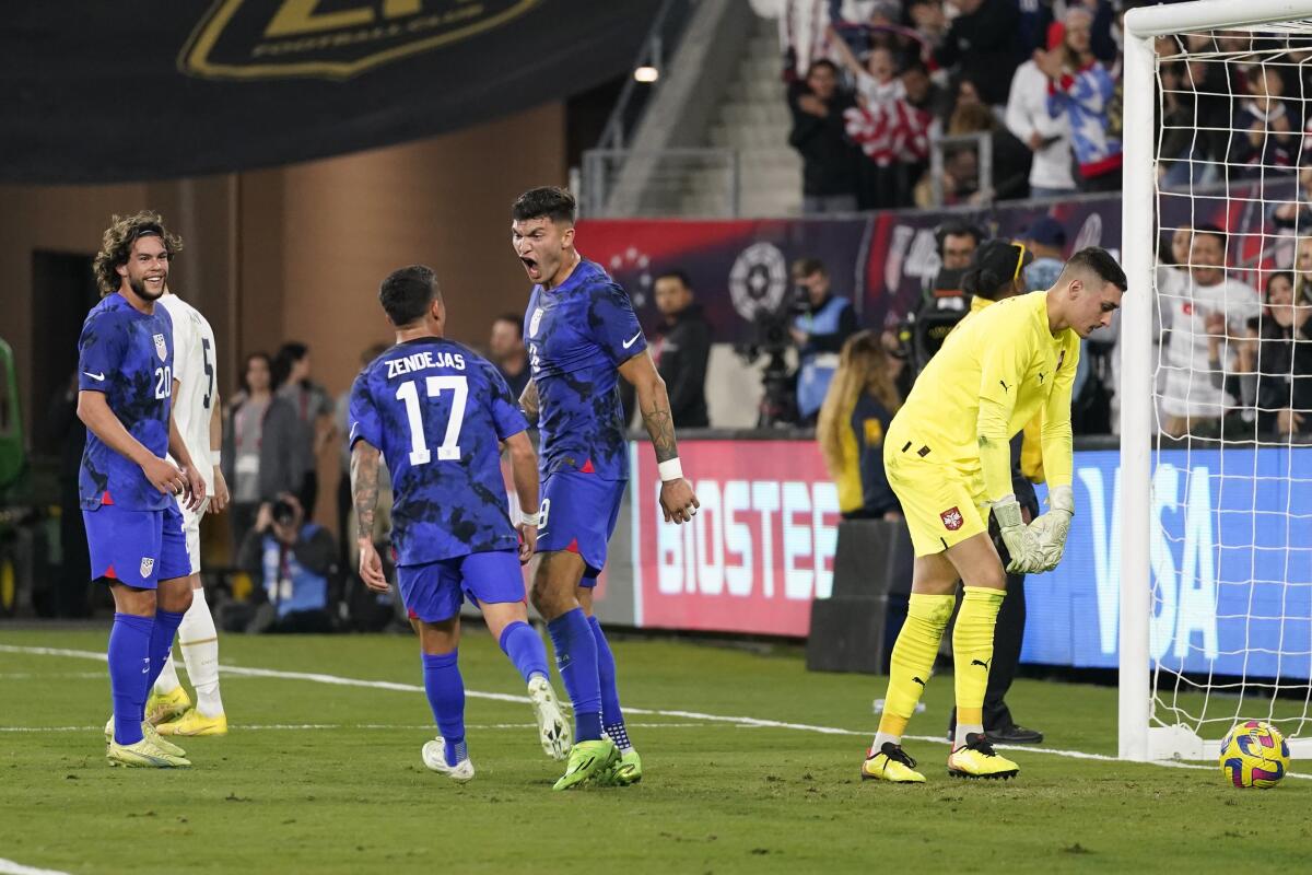 United States forward Brandon Vazquez celebrates after scoring against Serbia goalkeeper Dorde Petrović.