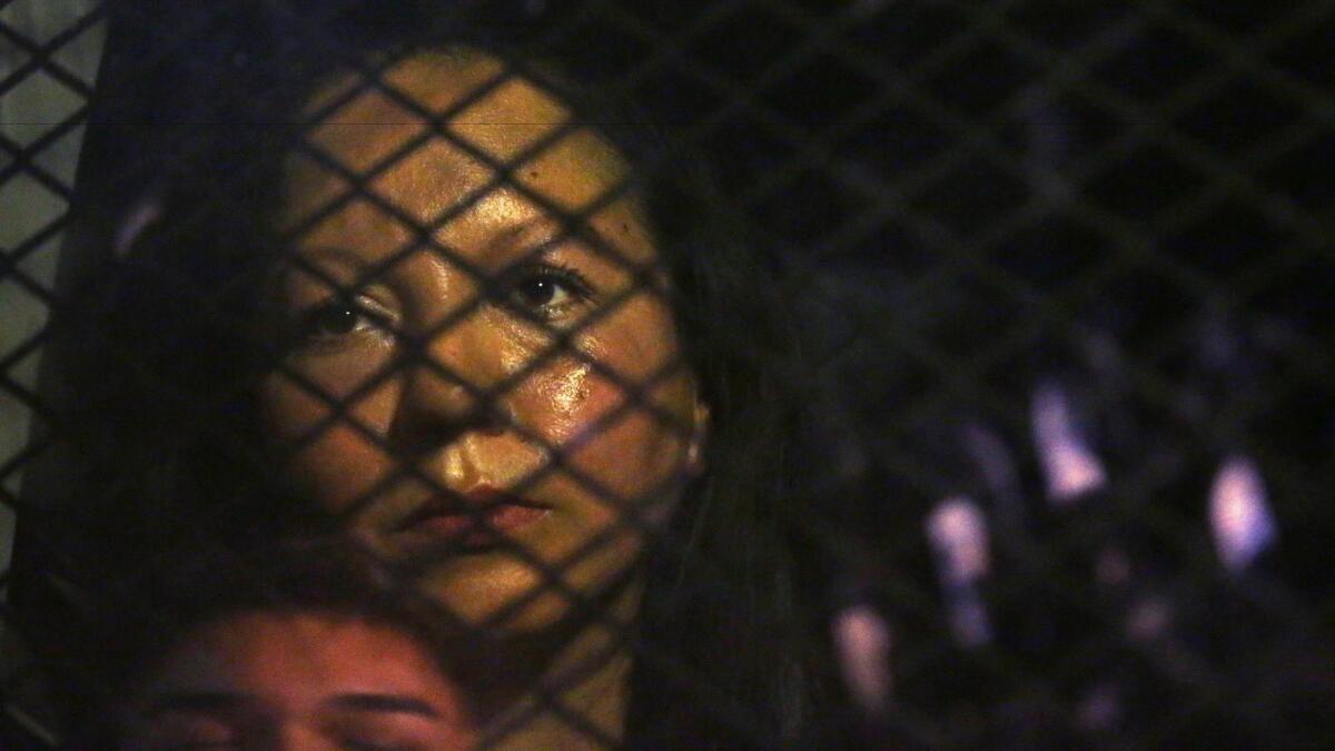 Guadalupe Garcia de Rayos is locked in a van blocked by protesters outside the Immigration and Customs Enforcement field office in Phoenix on Wednesday night.