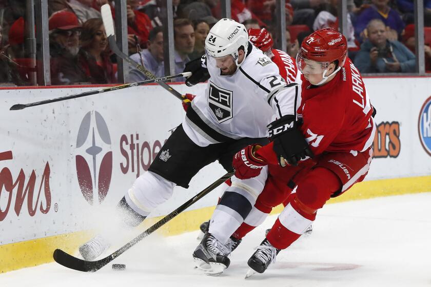 Red Wings center Dylan Larkin (71) knocks Kings defenseman Derek Forbort (24) off the puck during the second period Thursday.