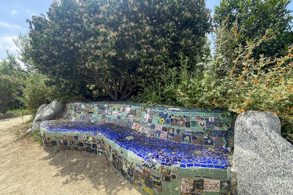 A mosaic-covered undulating concrete bench at Rio de Los Angeles State Park.
