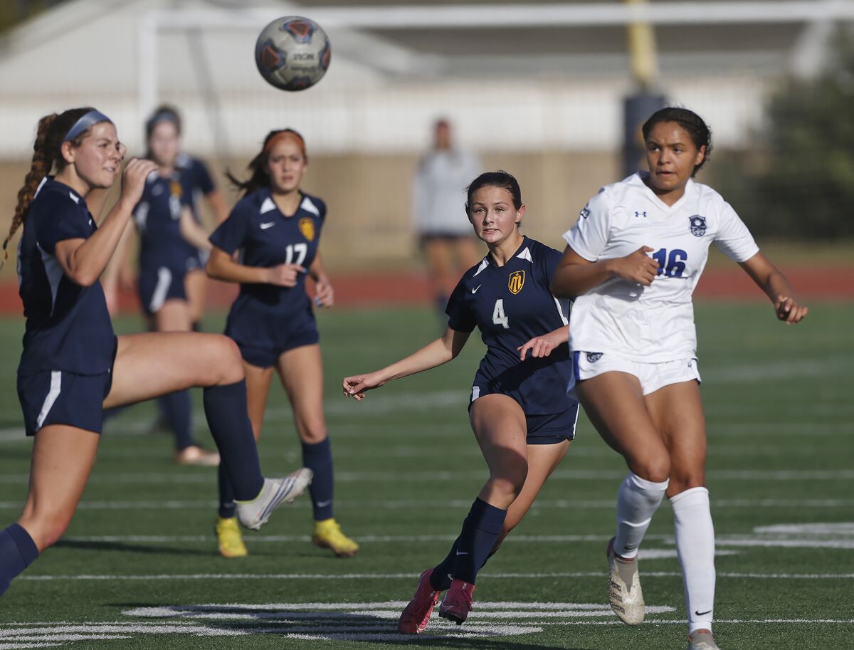 Marina's Izzie Krysinski (4) passes to Abby Kirby, as they make a rush up field against Webb on Friday.