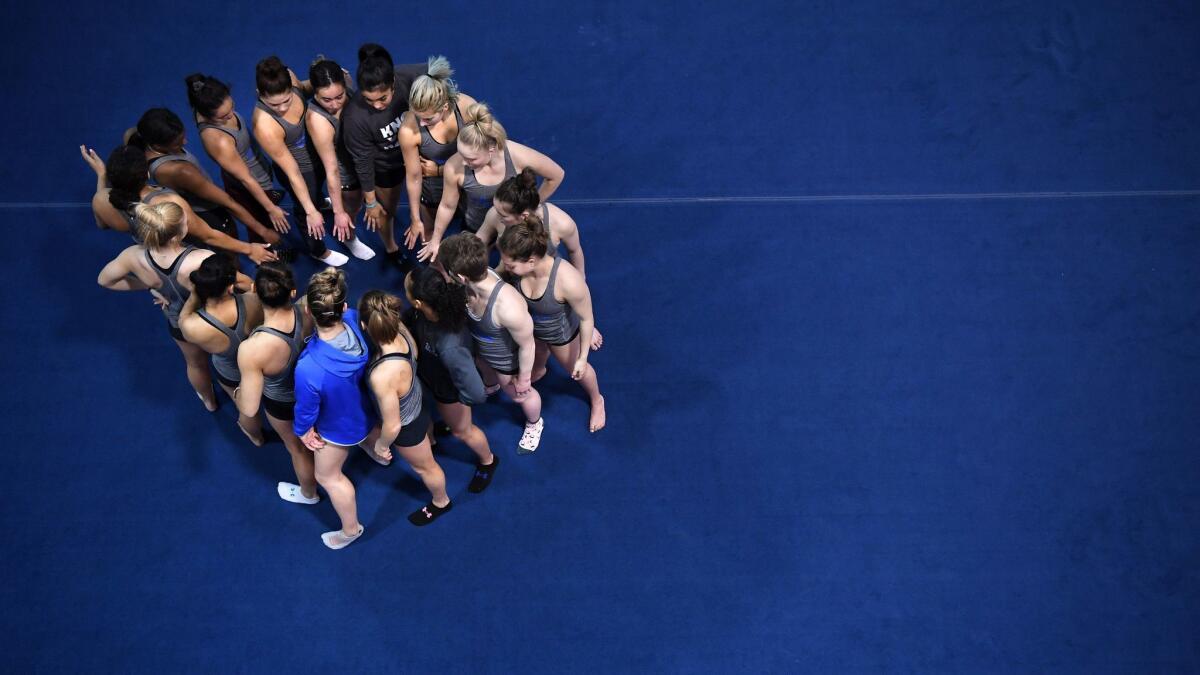 Gymnasts gather before practice at UCLA on March 23, 2019.