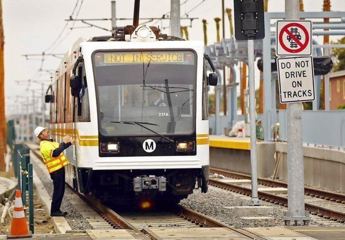 A worker checks a Metro Expo Line train before testing a street crossing last spring.