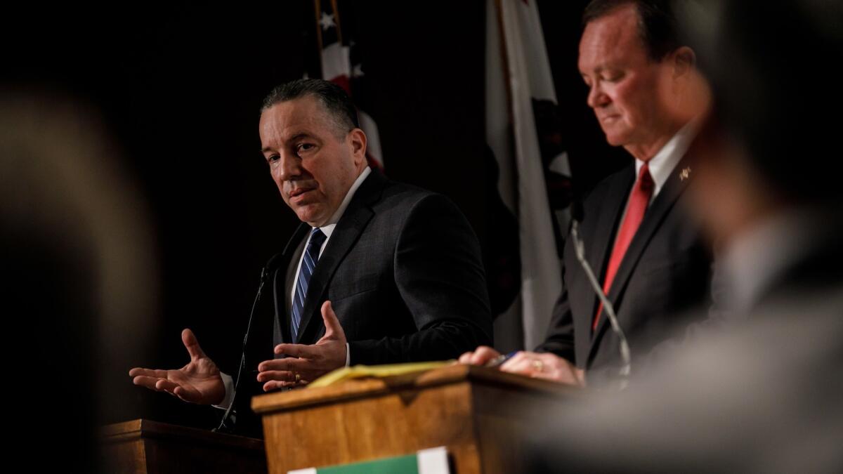 Retired Sheriff's Lt. Alex Villanueva debates L.A. County Sheriff Jim McDonnell at an event hosted by the Professional Peace Officers Association, in Los Angeles, Calif., on July 23, 2018.