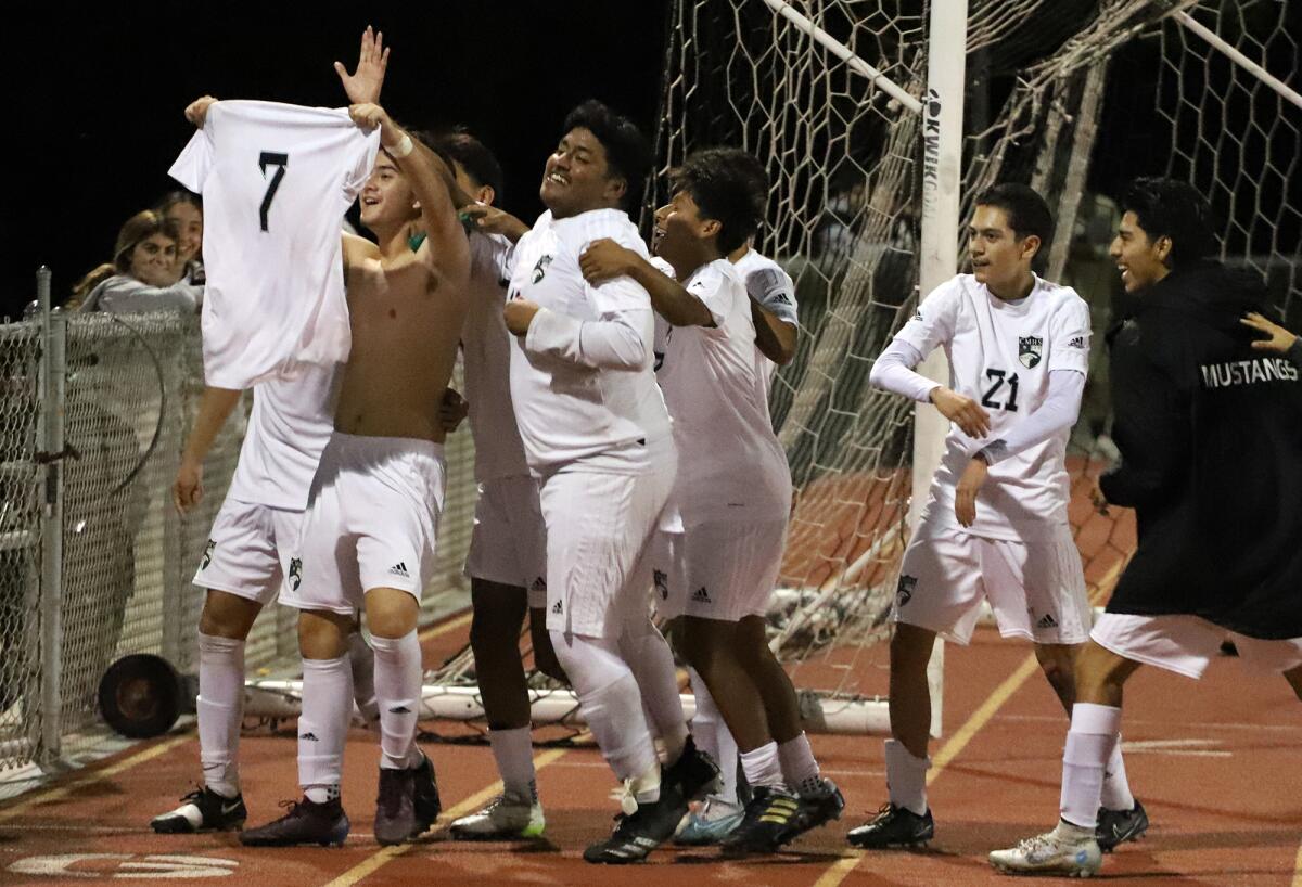Costa Mesa's Nathen Rocha (7) celebrates with his team after scoring a goal against Estancia in the Battle for the Bell.