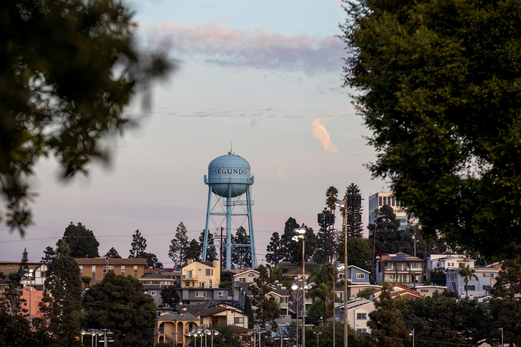 A water tower rises above a surrounding neighborhood  
