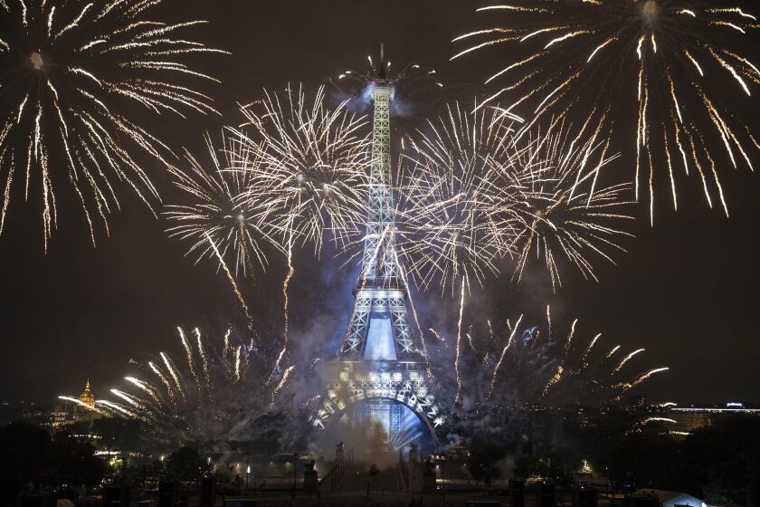 Fireworks illuminate the Eiffel Tower in Paris during Bastille Day celebrations late Wednesday, July 14, 2021. France has celebrated its national holiday with thousands of troops marching in a Paris parade and traditional parties around the country. Last year's Bastille Day events were scaled back because of virus fears. (AP Photo/Lewis Joly)