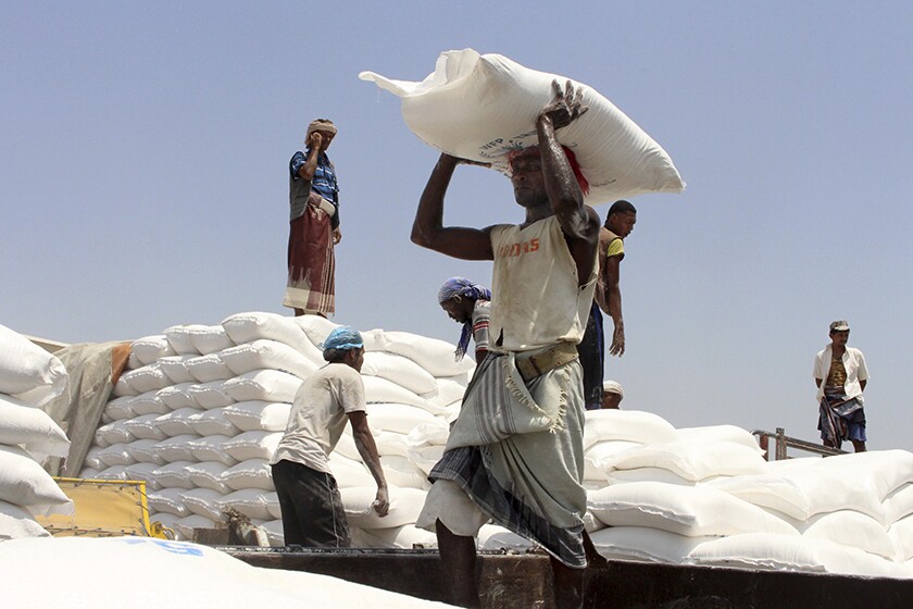 Men help deliver U.N. aid in Hajjah, Yemen, in 2018.
