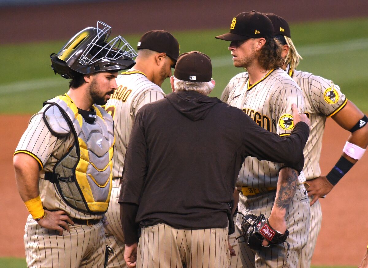 Padres starter Chris Paddack gets a visit from pitching coach Larry Rothschild during the third inning Thursday night.