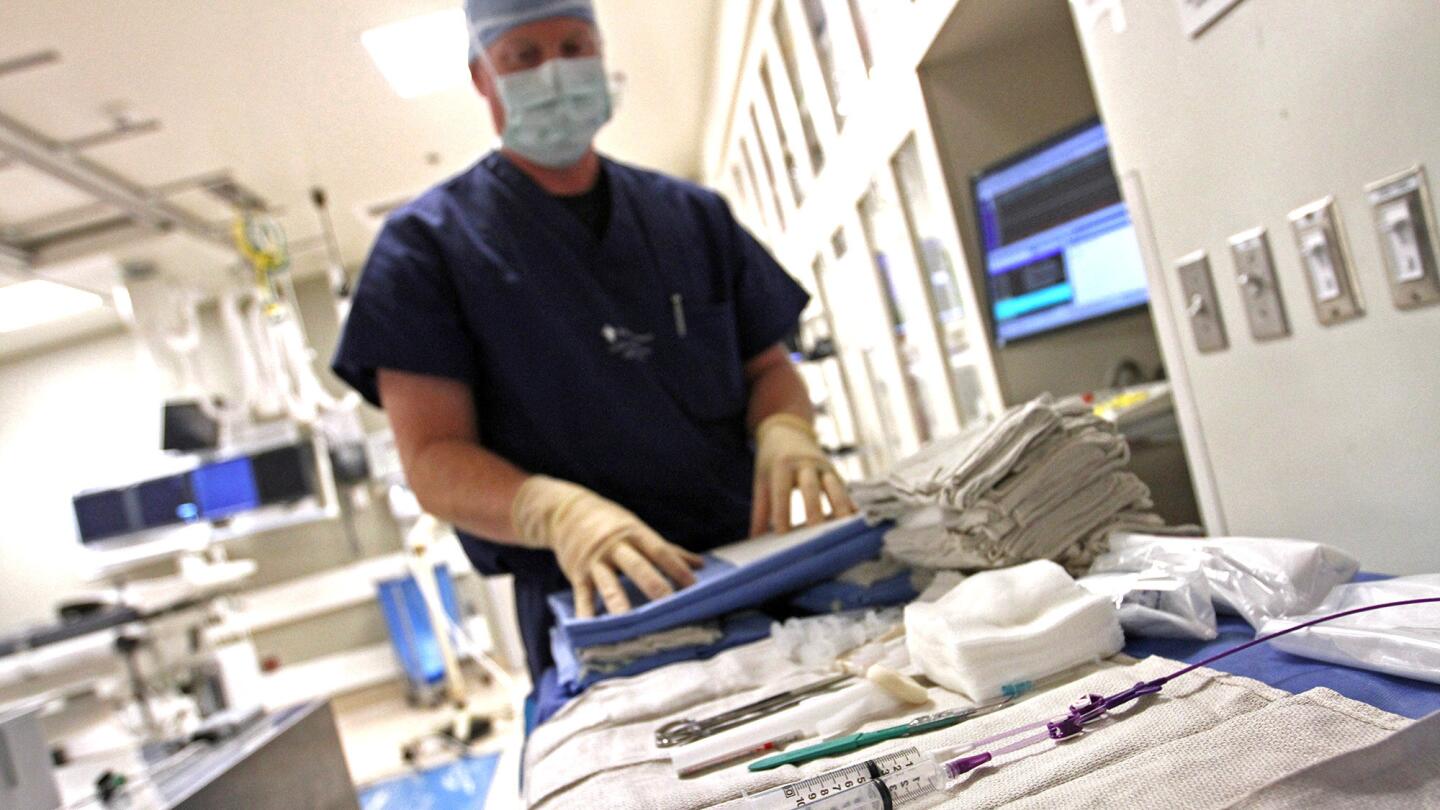 Technician Ryan Lindner lays out sterile catheter tubes for an operation in the catheter lab at Providence Little Company of Mary Medical Center in Torrance.