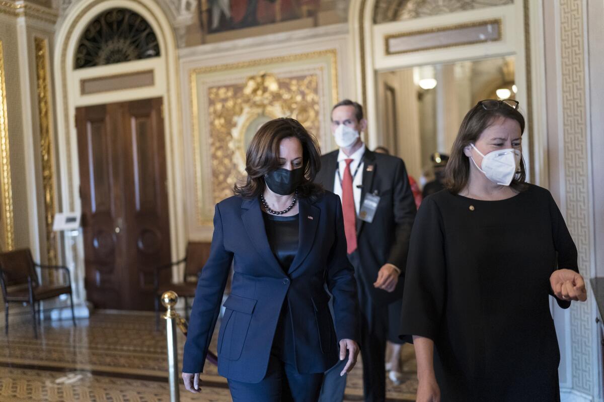 Kamala Harris walks toward the Senate chamber. 