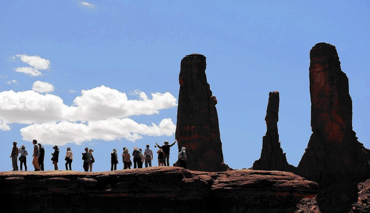 Tourists take pictures in Monument Valley on the Arizona-Utah border.