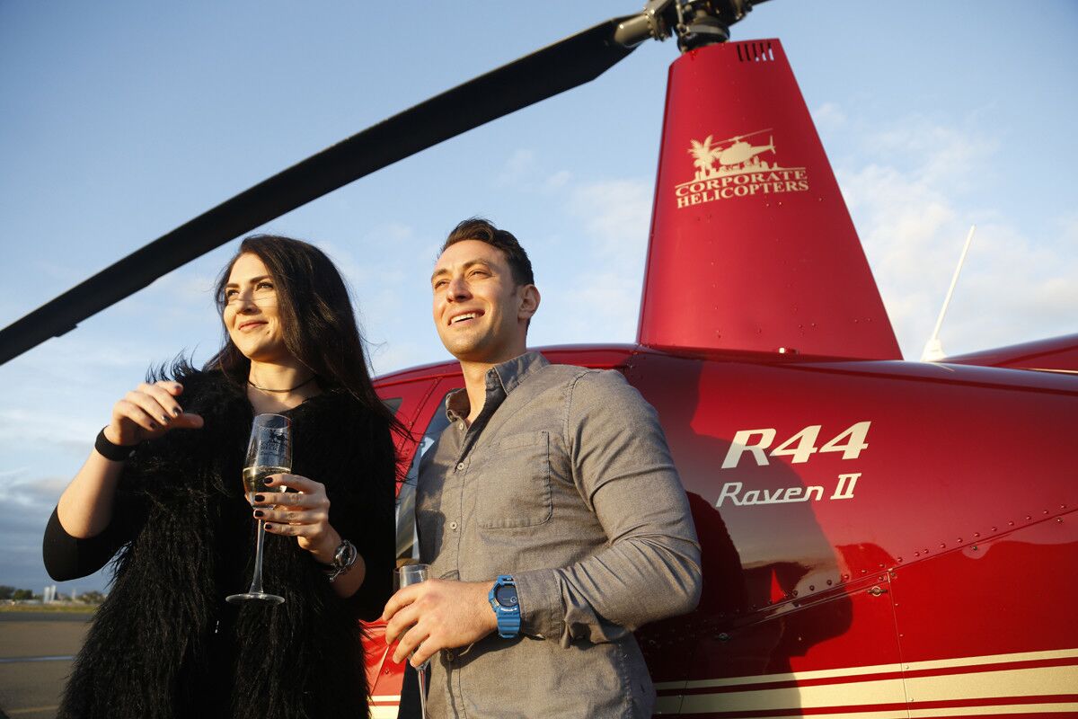 Blind daters Zlata Sushchik, left, and Scott Schindler prepare to take flight on the Romance Tours provided by Corporate Helicopters. (David Brooks / Union-Tribune)