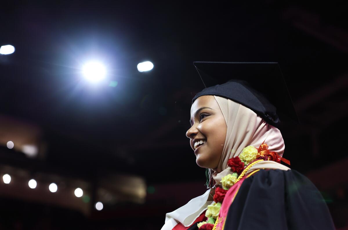 Asna Tabassum smiles in her cap and gown.
