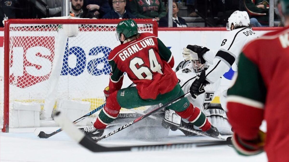 The Wild's Mikael Granlund (64) scores the game-winning goal against Kings goalie Jonathan Quick in overtime Monday.