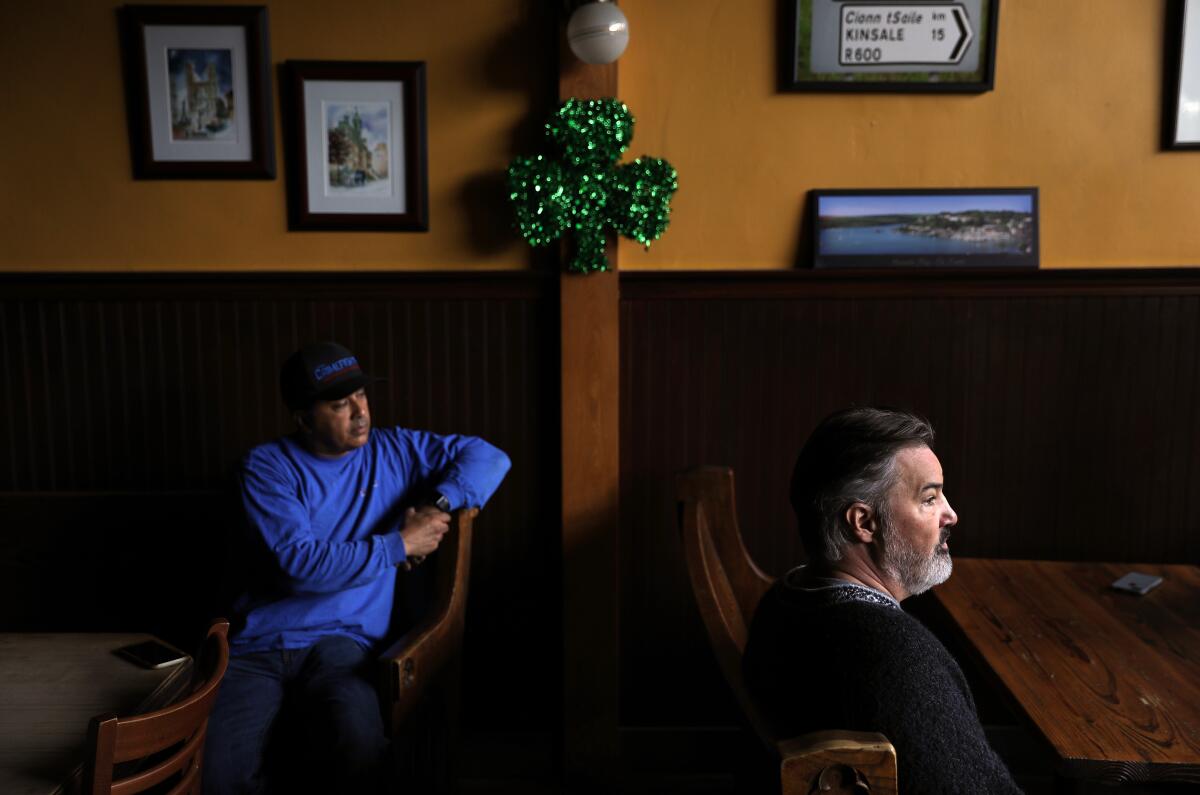 Pub owner Joseph Griffin, right, with employee Robert Vazquez