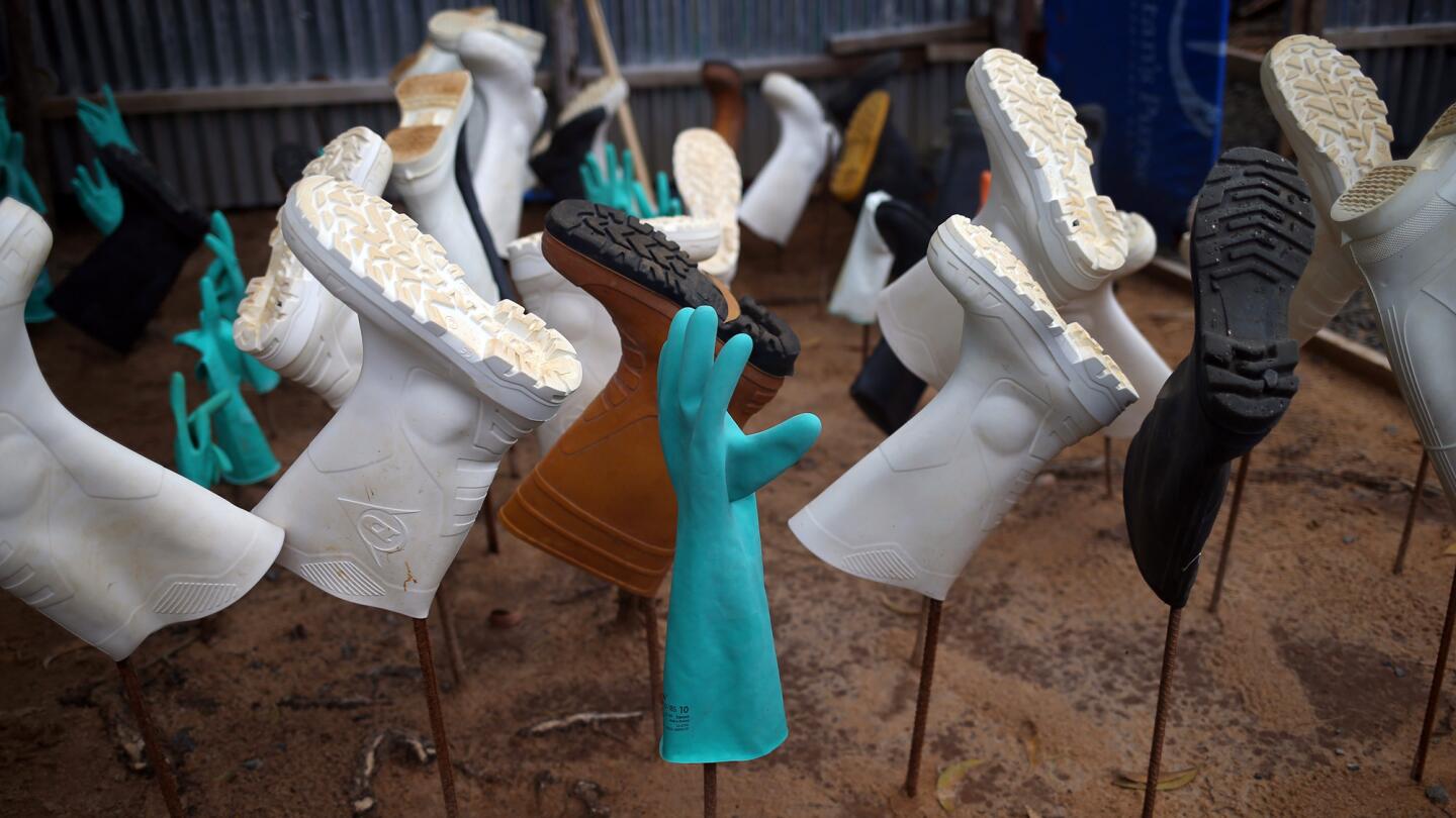 Sanitized gloves and boots hang to dry as a burial team collects Ebola victims from a Ministry of Health treatment center for cremation on Oct. 2 in Monrovia, Liberia.