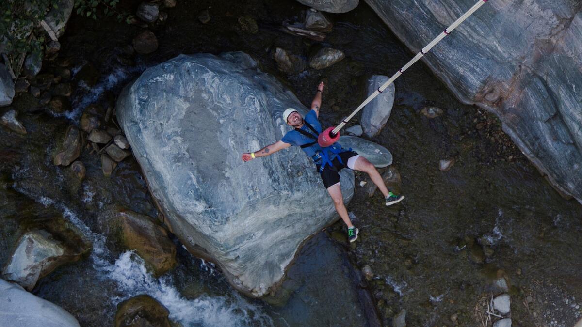 A bungee jumper dangles over the San Gabriel River after doing a backward plunge off the Bridge To Nowhere.