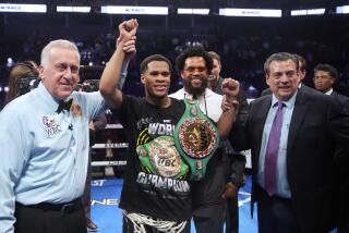 Devin Haney, center, celebrates after defeating Regis Prograis in the WBC super lightweight title.