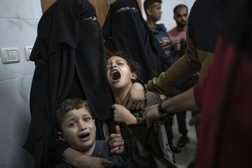 Palestinians mourn their relatives killed in the Israeli bombardment of the Gaza Strip, in the hospital in Khan Younis, Saturday, Nov. 11, 2023. ( AP Photo/Fatima Shbair)