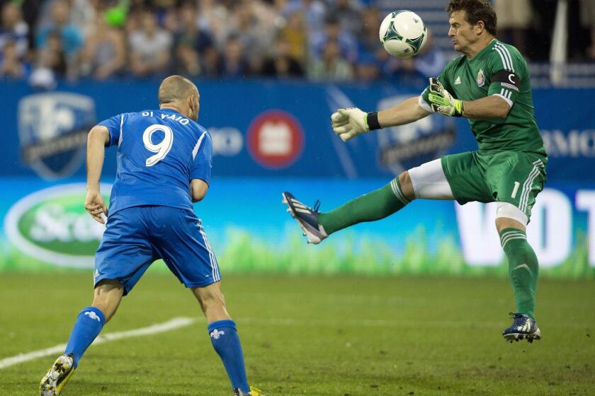 Chivas USA goalie Dan Kennedy, right, makes a save against Montreal's Marco Di Vaio during a game last season.