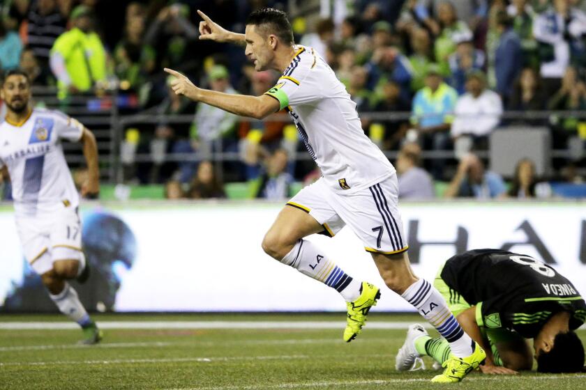 Galaxy forward Robbie Keane and Sounders midfielder Gonzalo Pineda react after Keane scored in the first half Sunday night in Seattle.