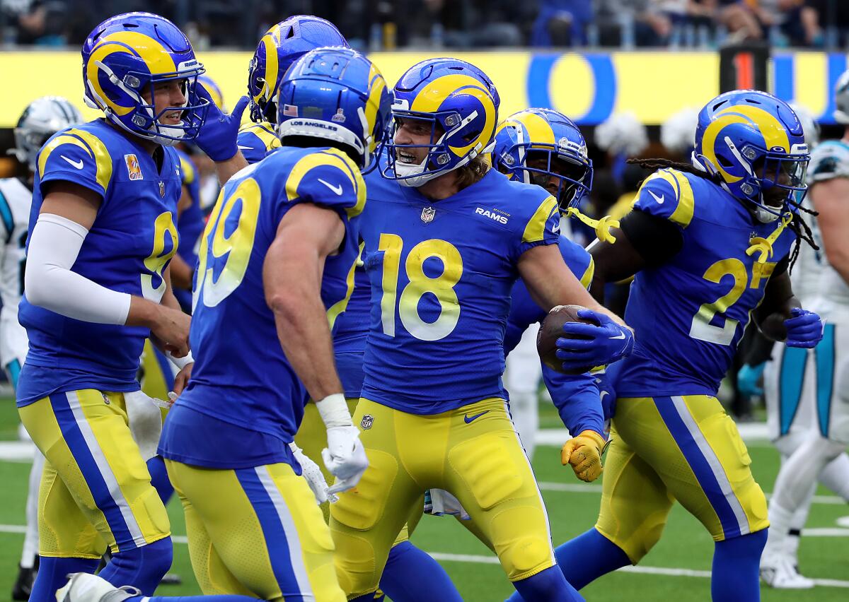 Rams receiver Ben Skowronek (18) is congratulated by teammates after running 17 yards for a touchdown against Carolina.