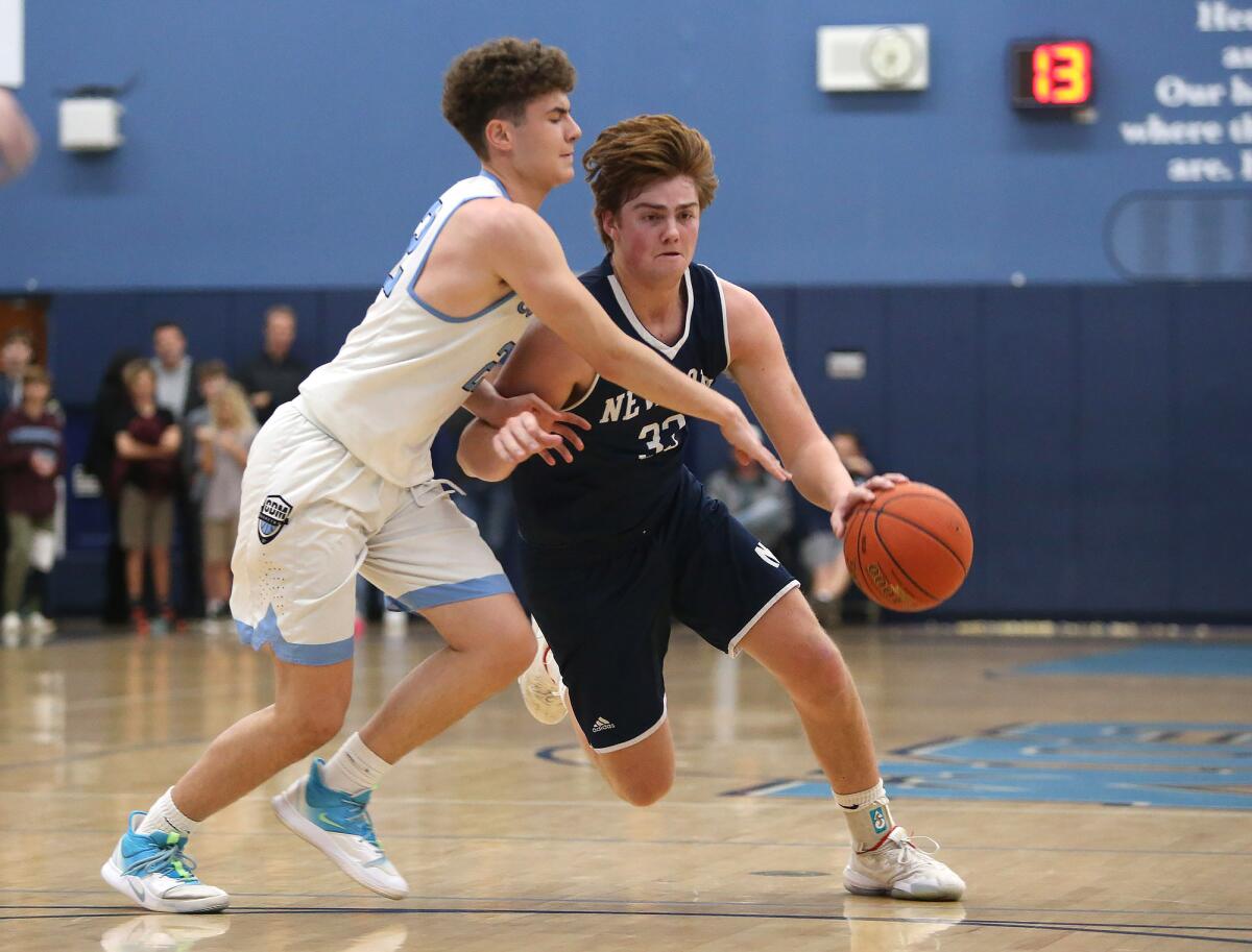 Newport Harbor's Robbie Spooner (33), pictured dribbling in a Jan. 17 game at Corona del Mar, helped the Sailors to a 50-48 win at Los Alamitos on Monday.