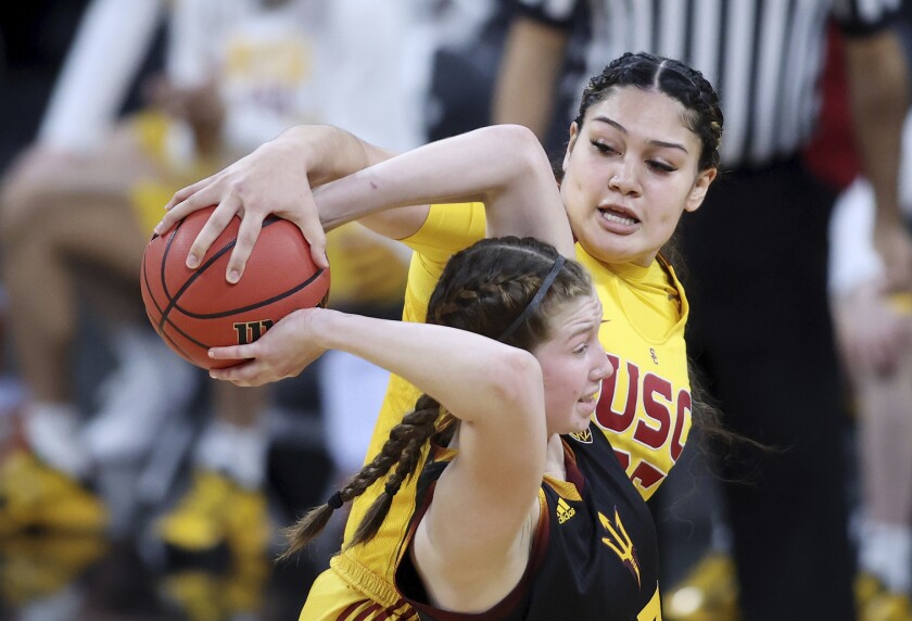 USC forward Alissa Pili steals the ball from Arizona State guard Maggie Besselink.