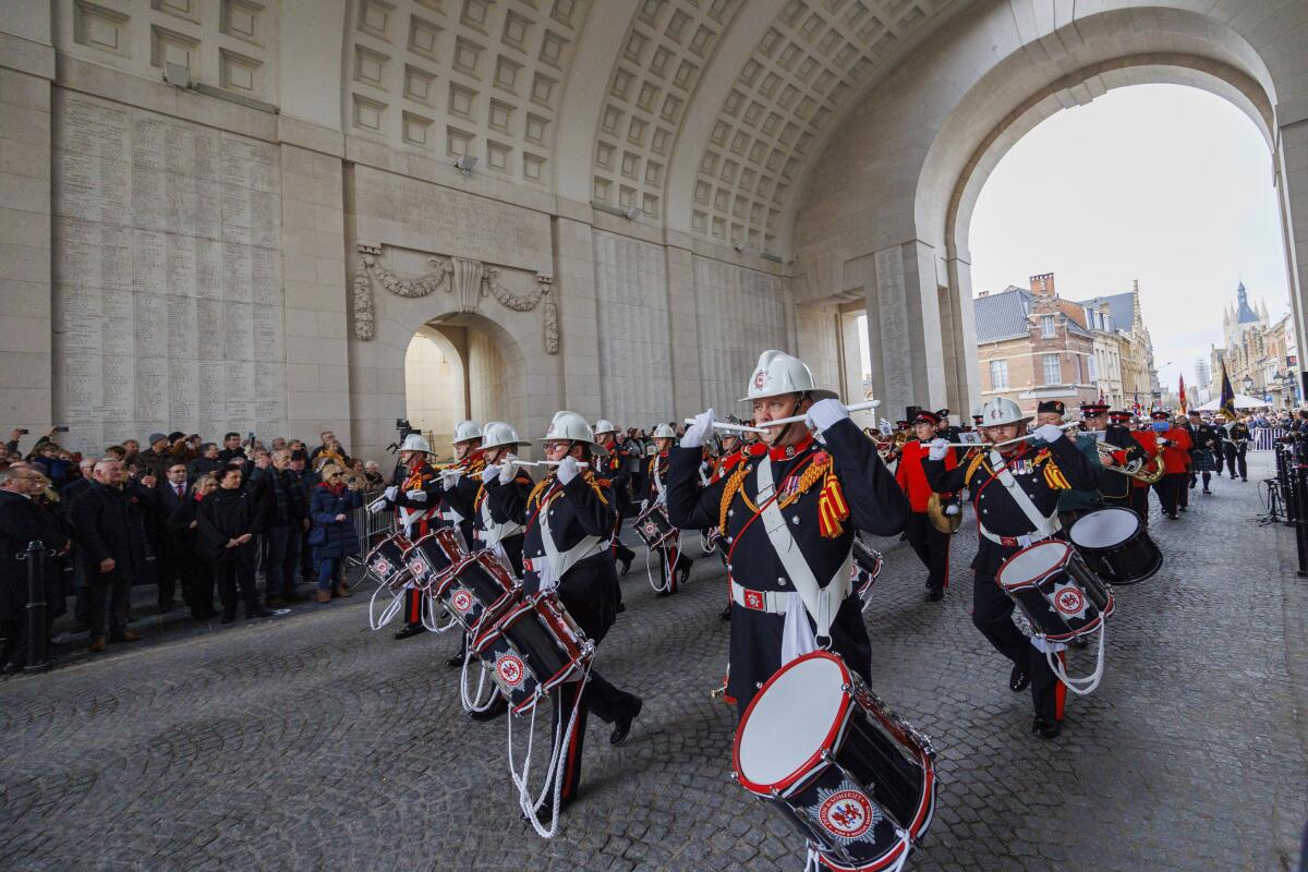 A drums and pipes band marches at the Menin Gate Memorial to the Missing in Belgium.