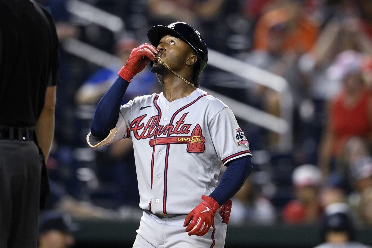 Atlanta Braves' Ozzie Albies looks skyward after his home run during the sixth inning of the team's baseball game against the Washington Nationals on Friday, Aug. 13, 2021, in Washington. The Braves won 4-2. (AP Photo/Nick Wass)