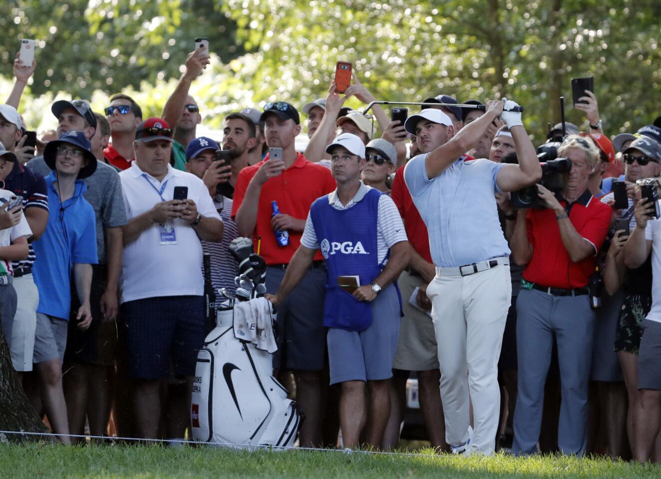 Brooks Koepka watches his approach shot on the 15th hole during the third round of the PGA Championship on Saturday.