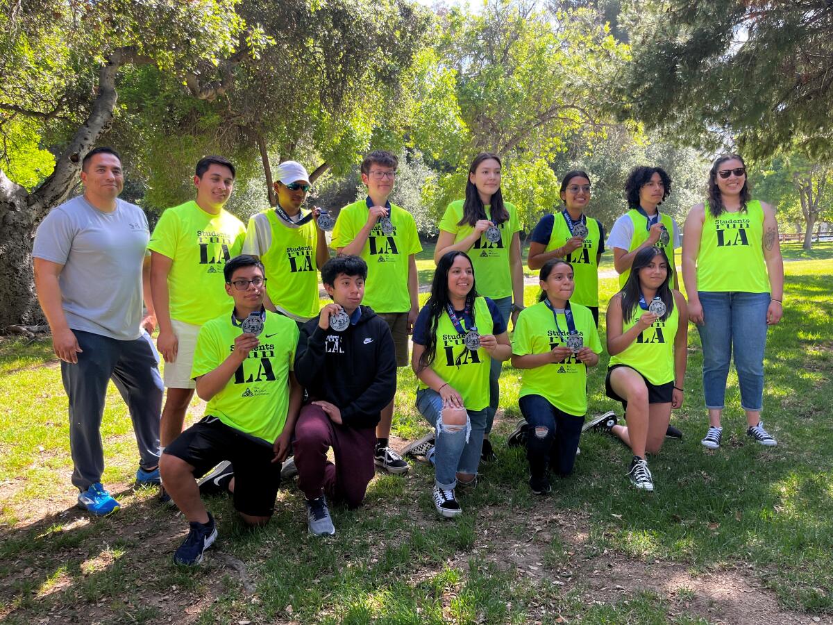 Students Run LA members pose for a photo with their L.A. Marathon medals.