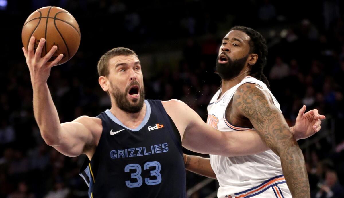 Marc Gasol (33), in one of his last games with the Grizzlies, tries to put up a shot against Knicks center DeAndre Jordan.