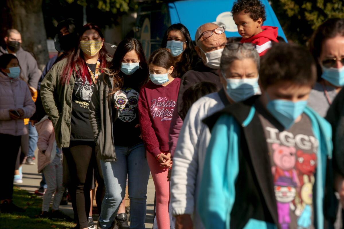 LAUSD students and staff wait in line for a COVID-19 test at a walk-up site.