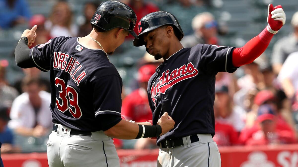 Indians shortstop Francisco Lindor, right, celebrates his three-run homer with teammate Giovanny Urshela during the fifth inning against the Angels on Thursday afternoon.