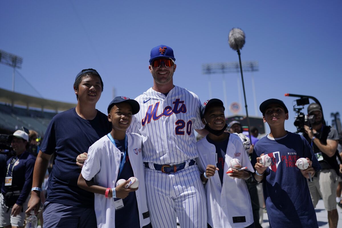 New York Mets' Pete Alonso takes photos with fans during batting practice a day before the 2022 MLB All-Star baseball game, Monday, July 18, 2022, in Los Angeles. (AP Photo/Jae C. Hong)
