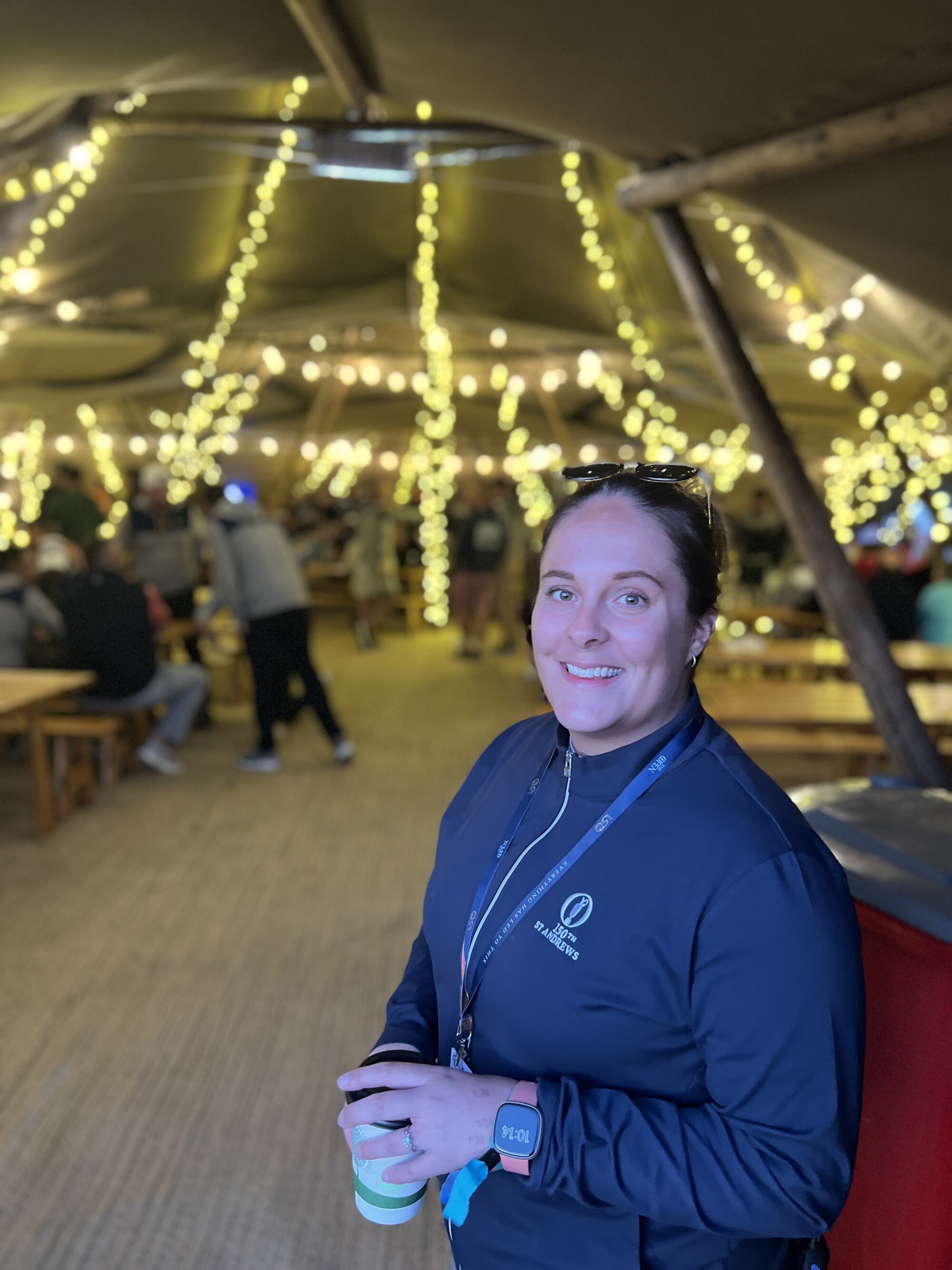 Alex Fothergill stands in front of the makeshift clubhouse that hosts various events for campers during the Open.