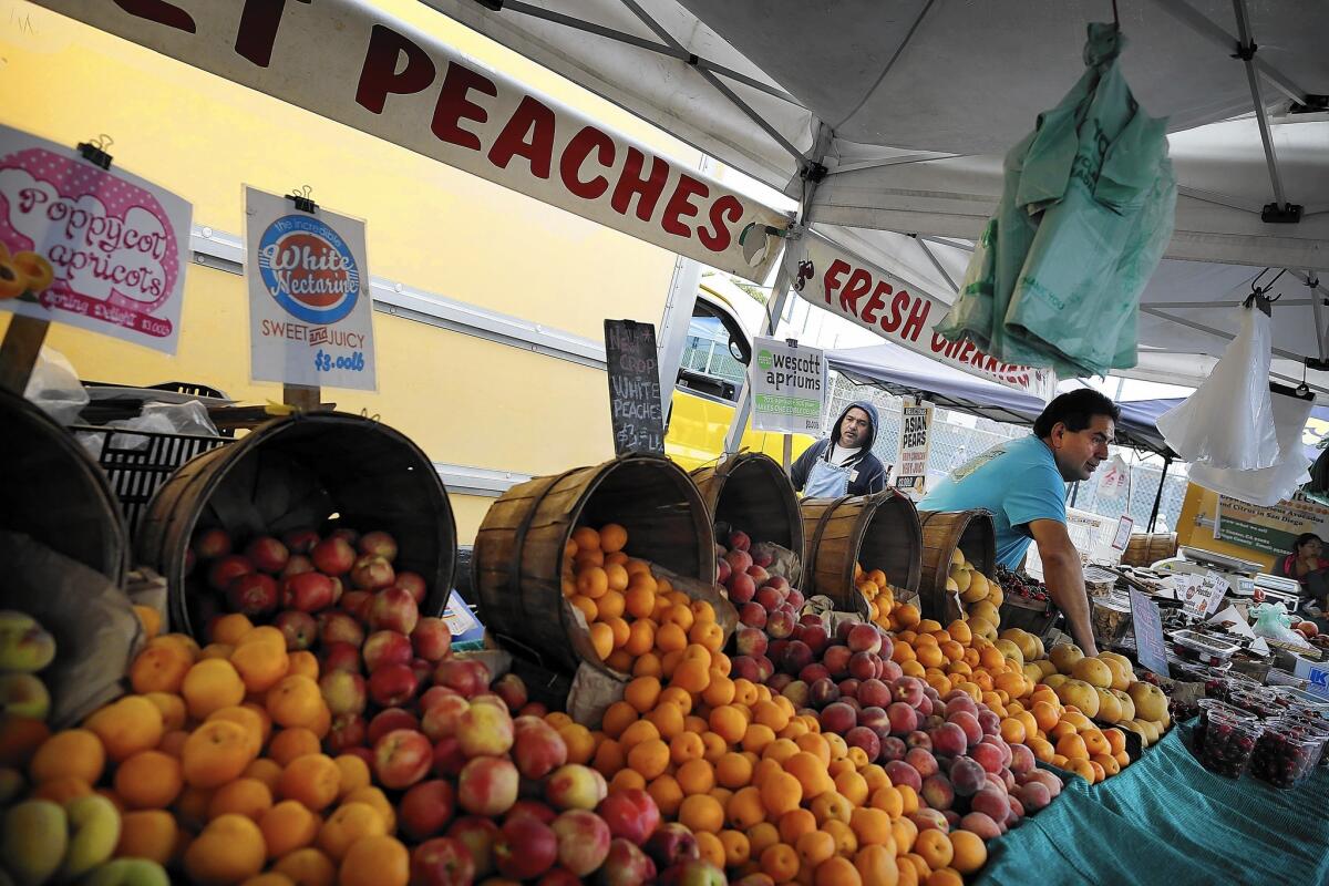 The warm weather has brought earlier harvests of "summer" stone fruits, such as these offered by Arnett Farms of Fresno at the Hermosa Beach farmers market on May 8.