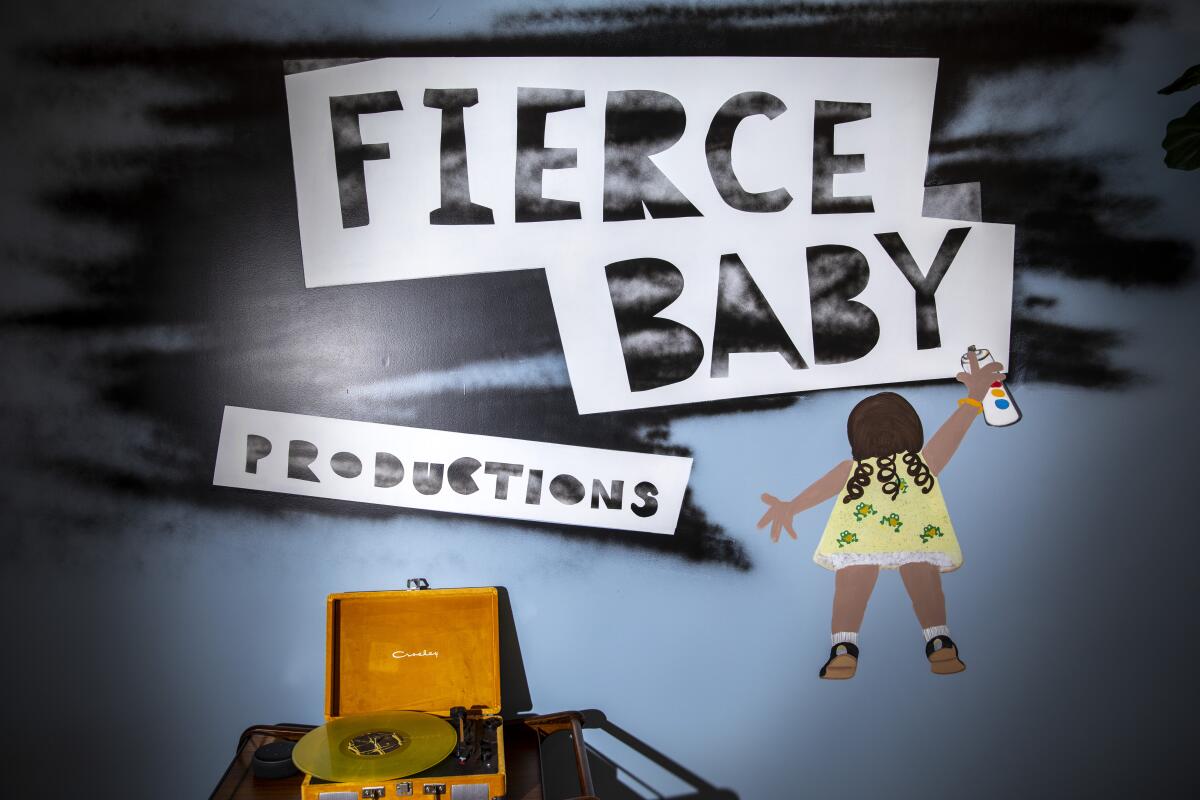 The logo for Fierce Baby Productions is a young girl spray painting