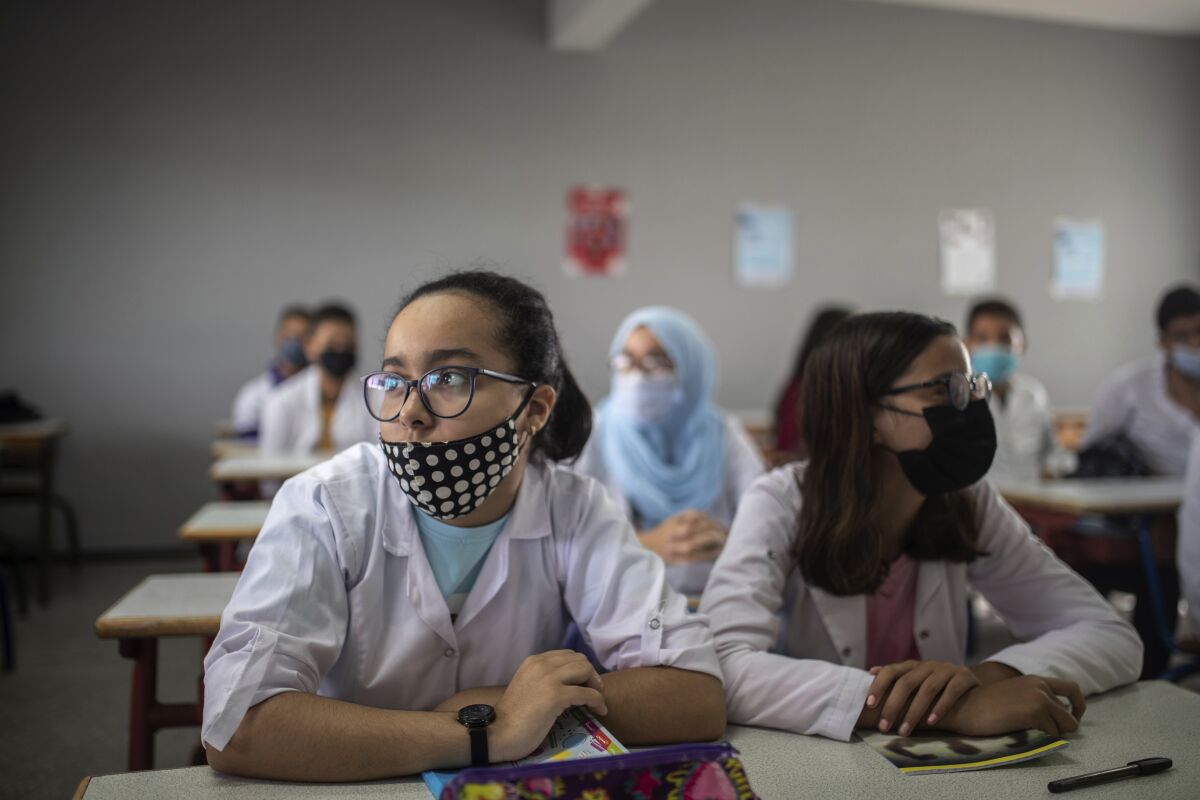 Students wear robes and face masks as they attend first day of new school year in Rabat, Morocco, Friday, Oct. 1 2021. Morocco delayed the return of schools until first of October to vaccinate 12-17 year old children against covid-19. (AP Photo/Mosa'ab Elshamy)
