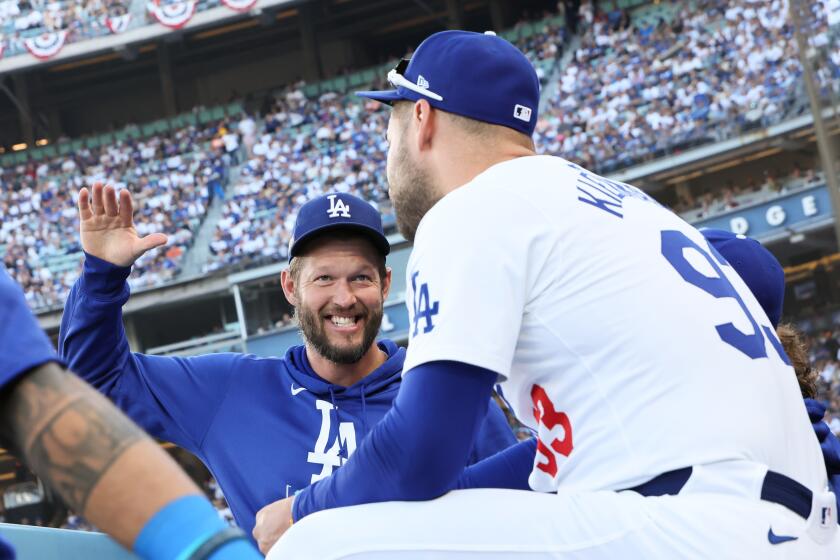 LOS ANGELES, CALIFORNIA - OCTOBER 13: Kevin Kiermaier #93 of the Los Angeles Dodgers talks with Clayton Kershaw in the dugout beforegame one of the National League Championship Series against the New York Mets at Dodger Stadium on Sunday, Oct. 13, 2024 in Los Angeles. (Robert Gauthier / Los Angeles Times)