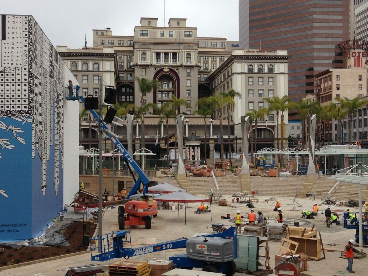 Construction workers race to finish last-minute elements at the Horton Plaza park expansion.