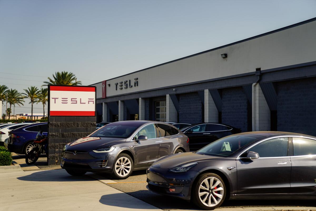 Several Tesla Model 3s parked outside a Tesla service center in Burbank.